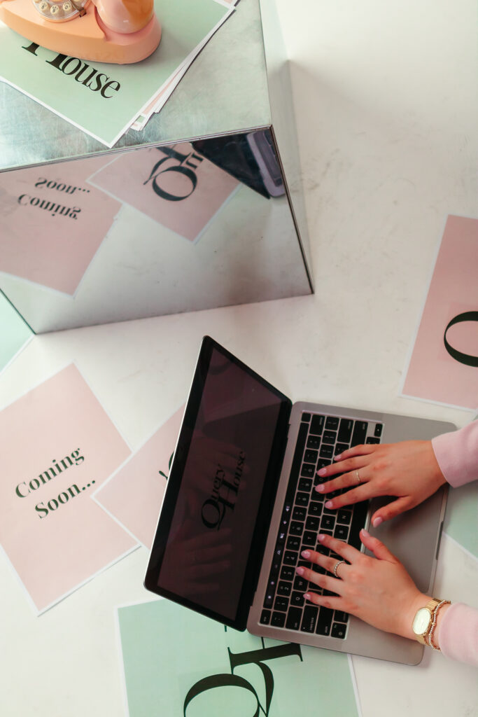 Woman working on laptop typing alt text into website for client